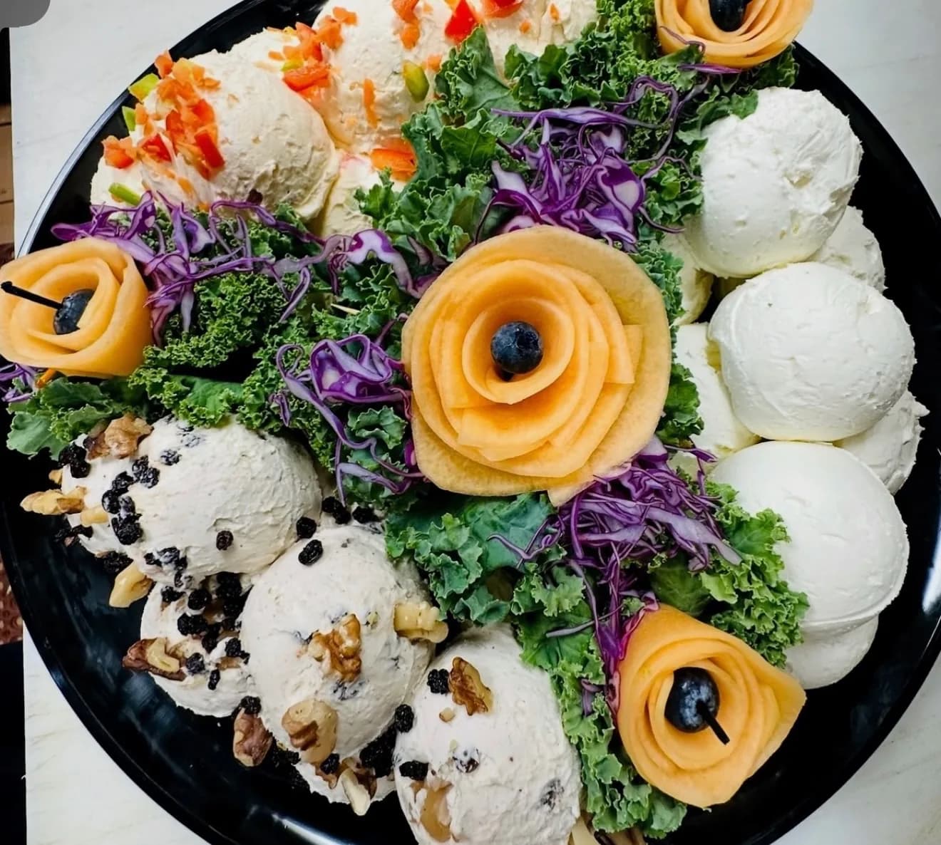 Assorted bagel and cream cheese catering platter with fresh spreads