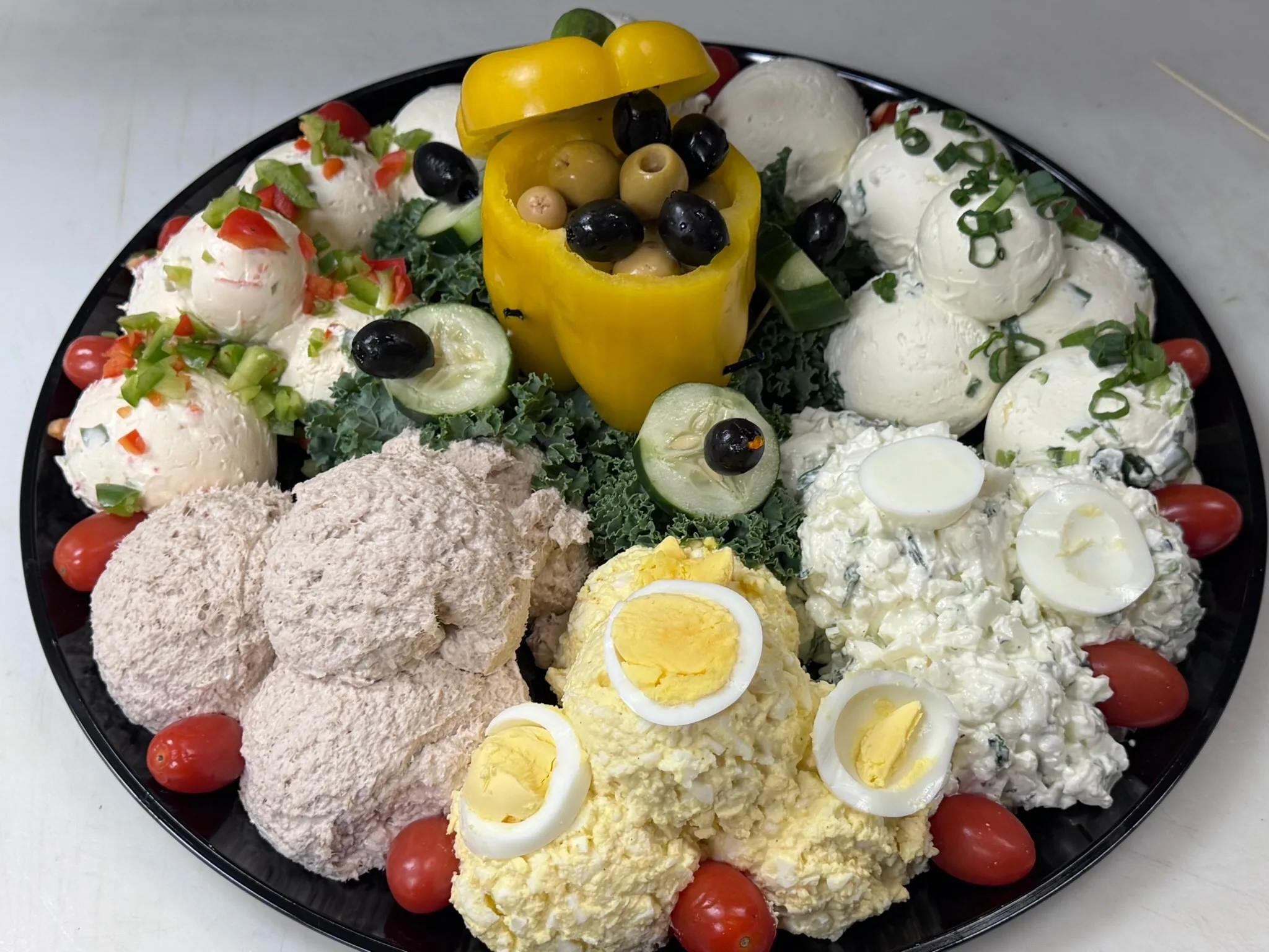 Cream cheese catering spread with bagels, berries, and assorted toppings