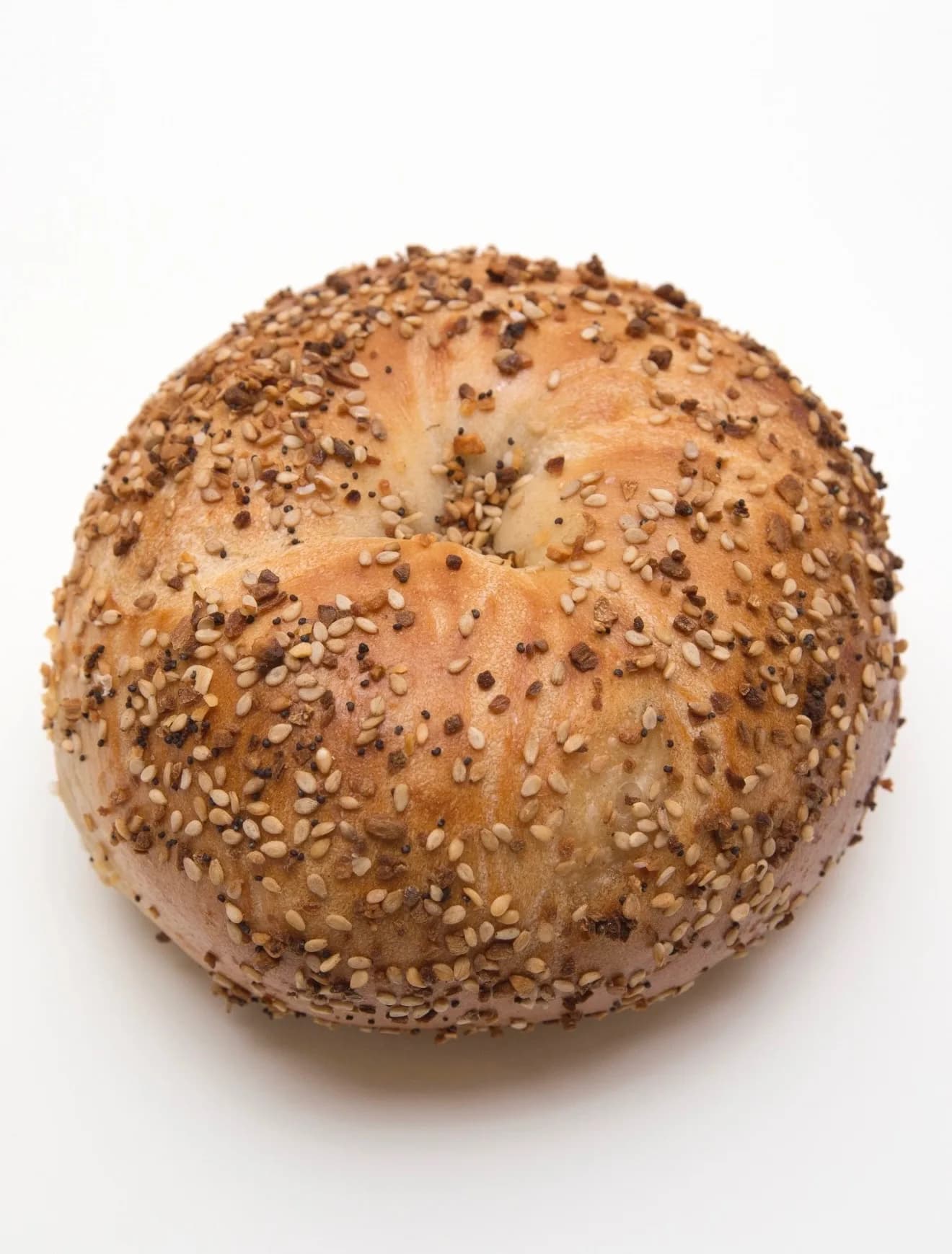The Everything bagel, top-down — sesame, poppy, garlic, onion, salt, all in one bite