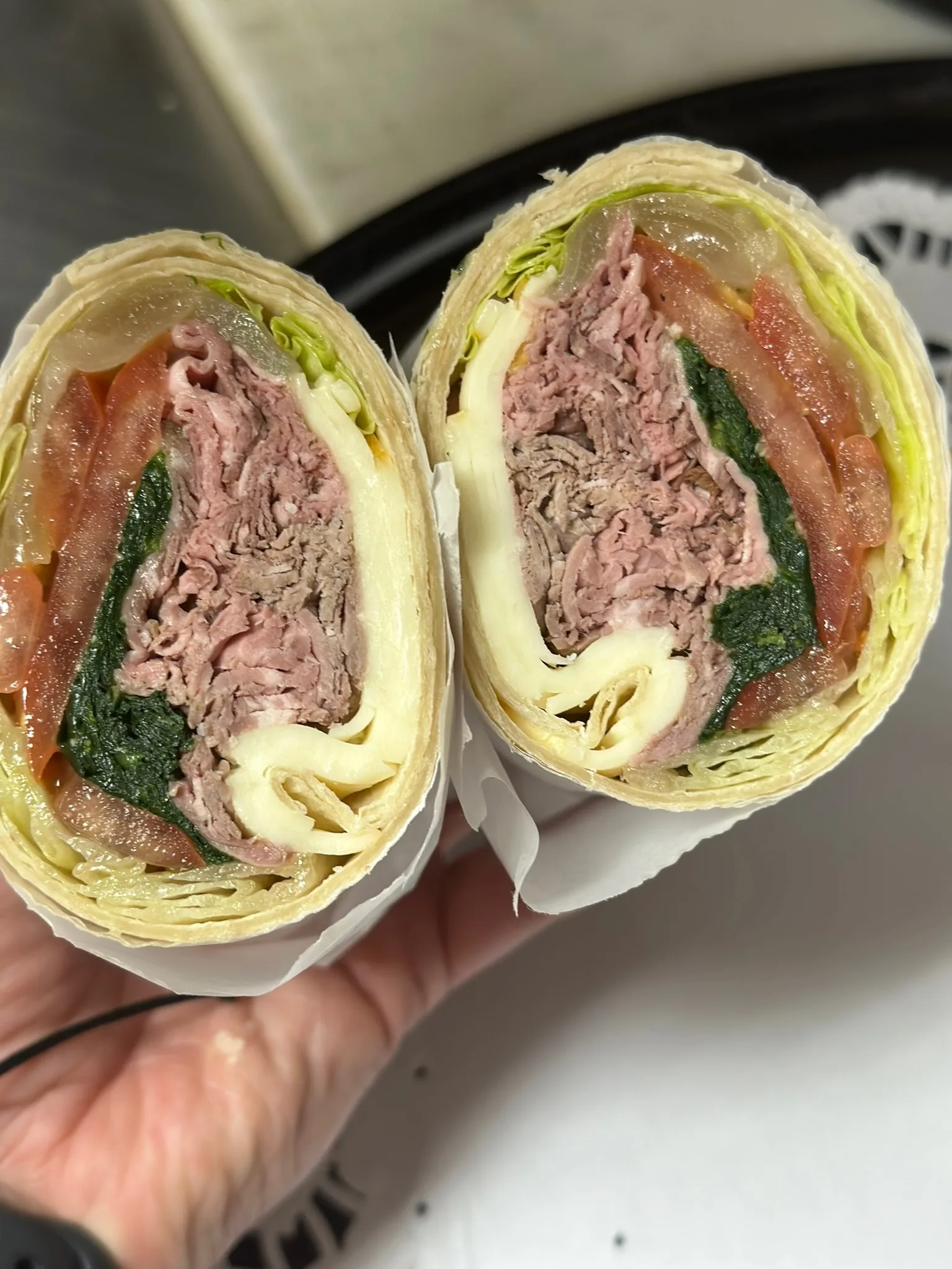 Roast Beef wrap — hand-sliced roast beef with provolone, tomato, and spinach